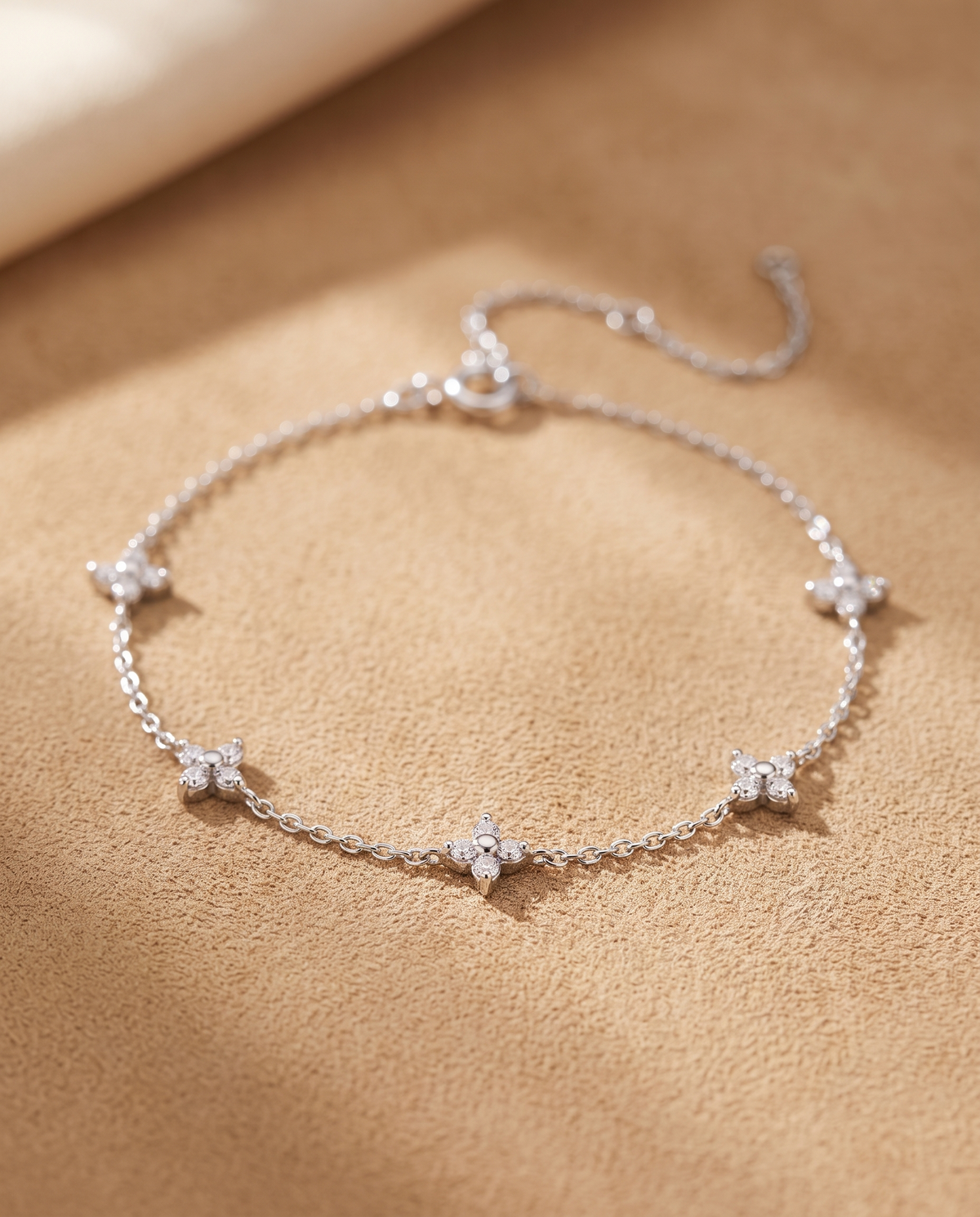 Silver moissanite star station bracelet on warm suede