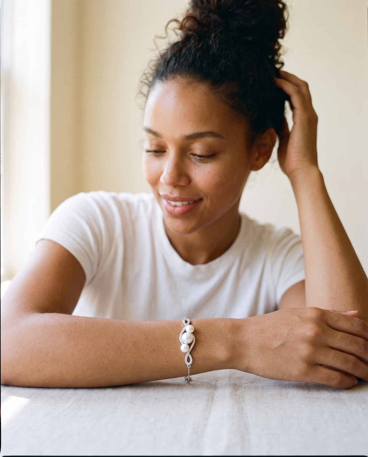 Infinity freshwater pearl bracelet worn