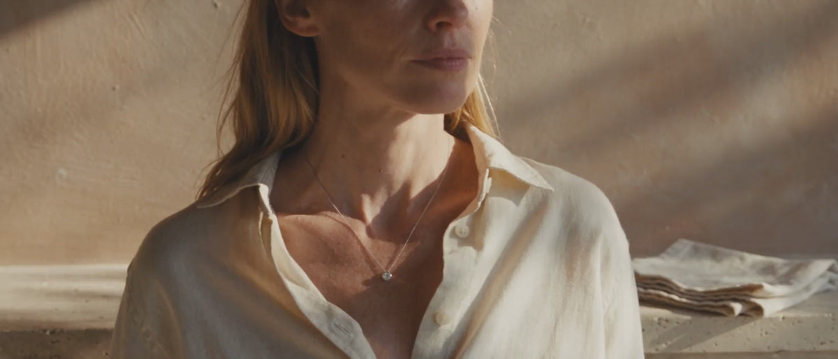 Model wearing Draycott & Co necklace, warm natural light, no loop